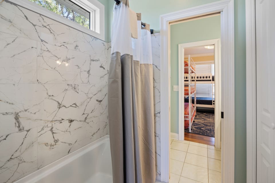 Shared shower for bedroom 3 and 4, but private toilet and sinks.