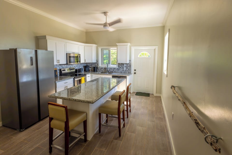 Fully equipped Kitchen with additional island seating.