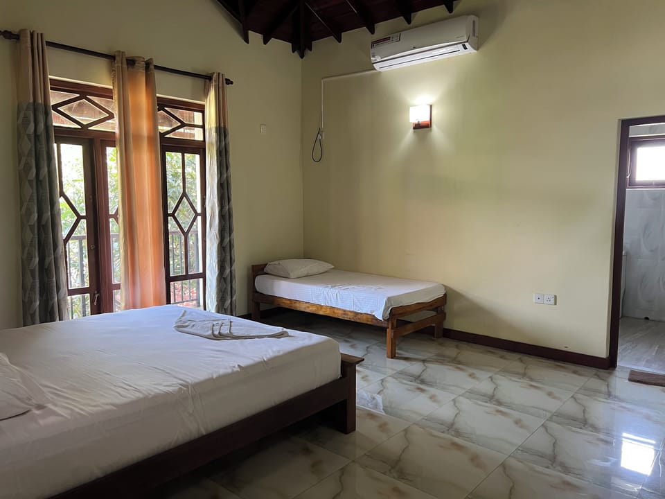 Triple Room, Balcony, Garden View | Iron/ironing board, free WiFi