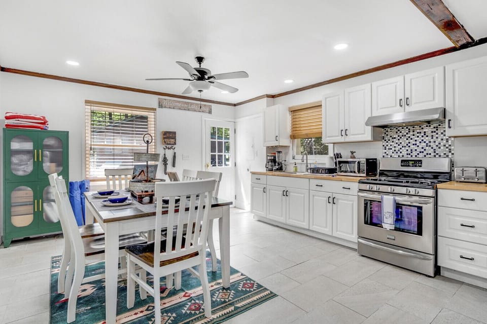 Spacious kitchen and dining area with modern appliances and family seating.