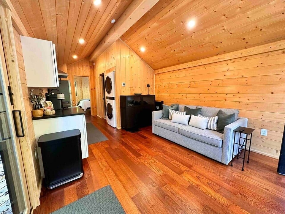 Cozy living area with plush sofa bed, smart TV, fast WiFi, and clean Scandinavian design.