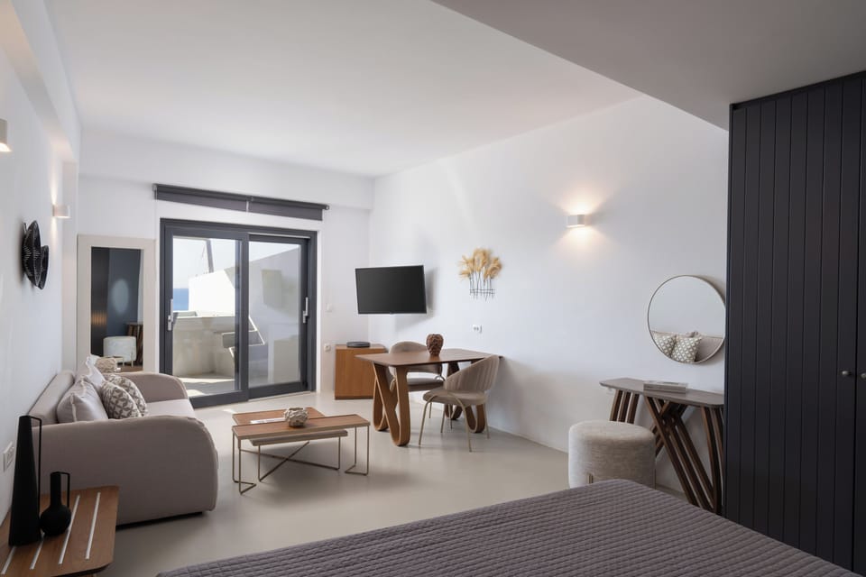 Spacious living room with siting area furniture  comfy sofa coffee and tea table Dinner table / workplace Flat TV set  Balcony