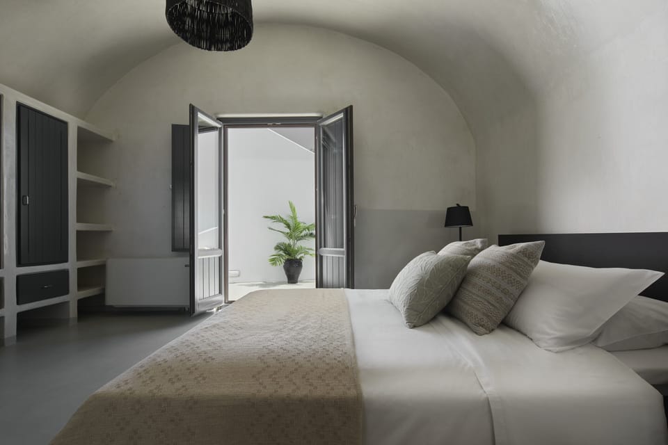 Master bedroom -luxuriating in crisp white linen bedding in a queen-size bed and easy access to your private terrace