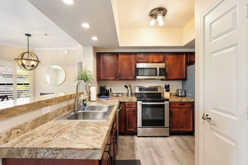 Fully stocked kitchen with dishwasher and coffee bar.