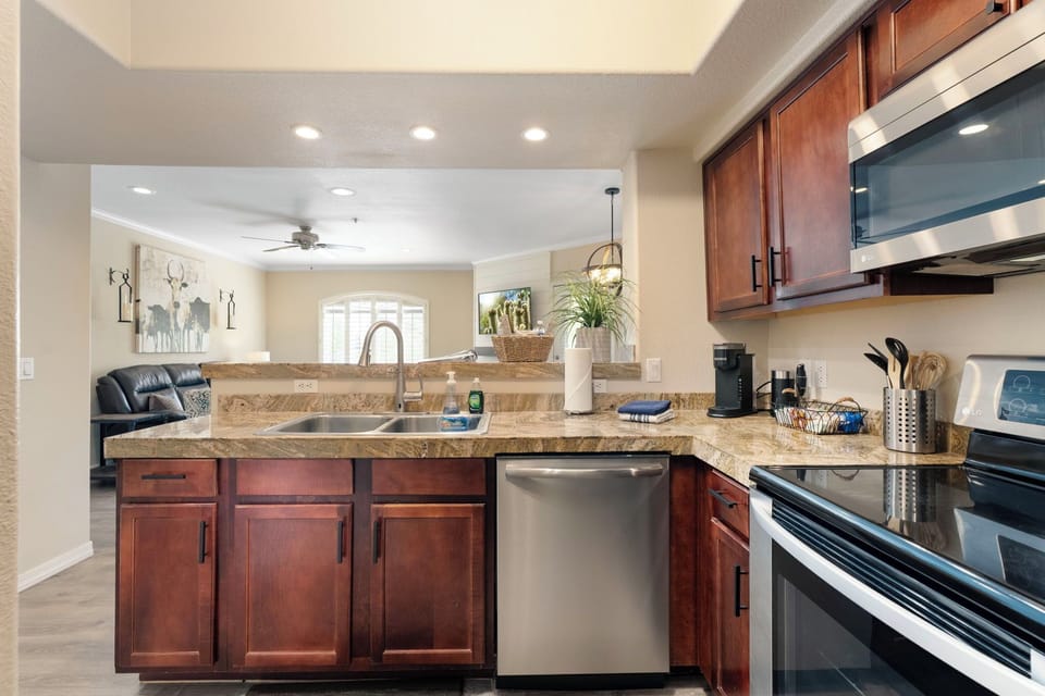 Fully stocked kitchen with dishwasher and coffee bar.