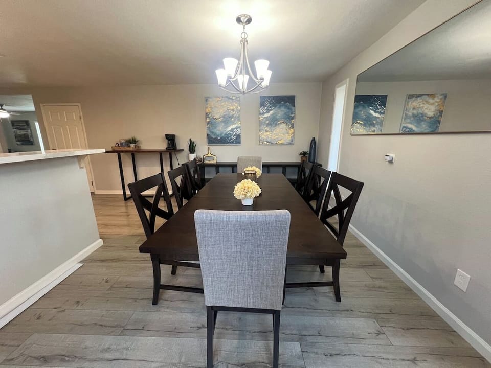 A beautifully designed dining area with a spacious table, stylish decor, and warm lighting. Perfect for hosting family meals and gatherings.