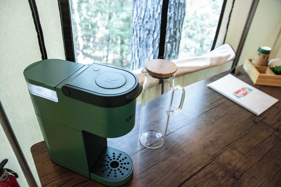 Equipped with a Keurig coffee maker, coffee pods, and cups. 