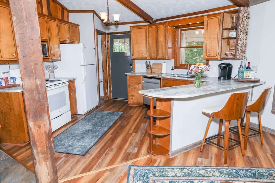 Full kitchen with refrigerator, stove, microwave, dishwasher and plenty of dishes