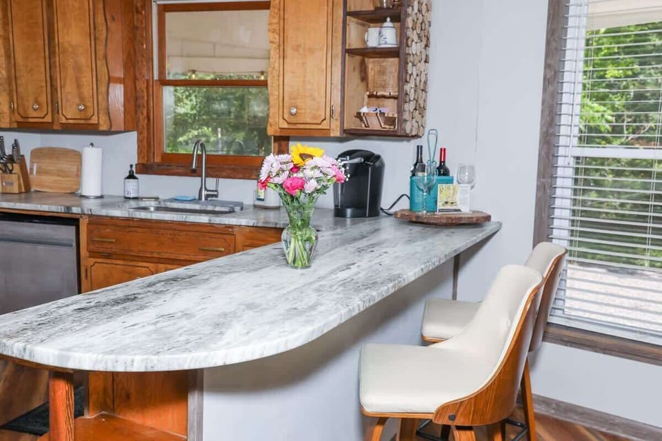 Full kitchen with refrigerator, stove, microwave, dishwasher and plenty of dishes