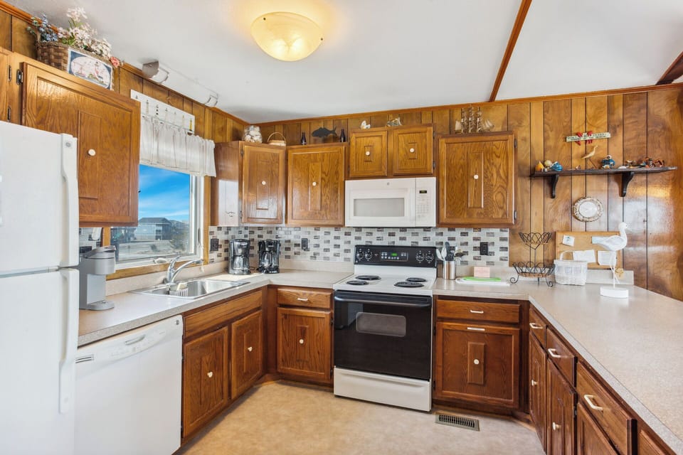 The Kitchen, with counter seating for four, is fully equipped for preparing meals that the whole family will enjoy.