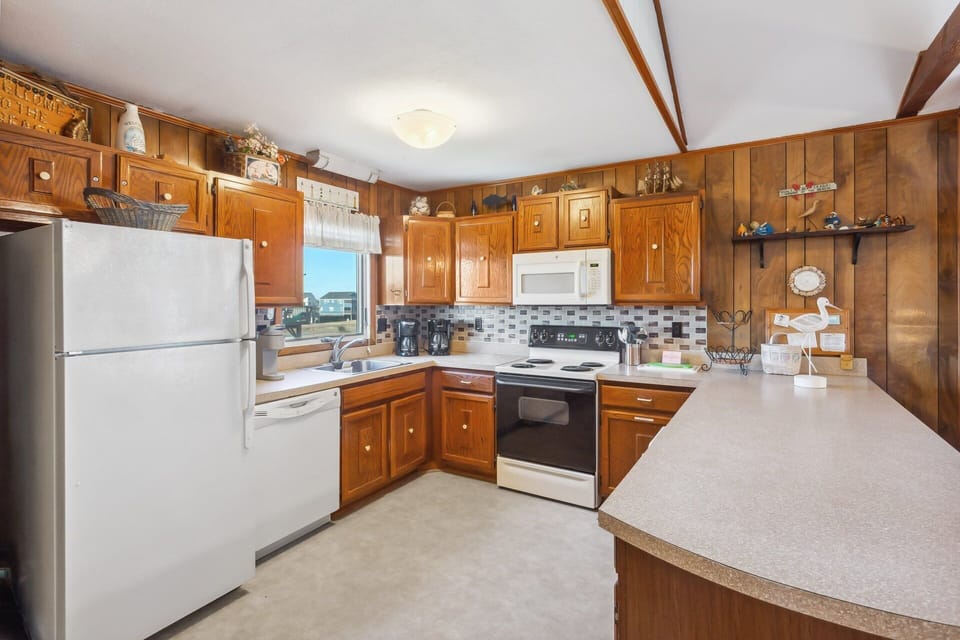 The Kitchen, with counter seating for four, is fully equipped for preparing meals that the whole family will enjoy.