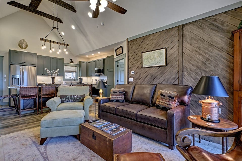 Living room with pullout sofa bed, Kitchen area and doorway to queen bedroom