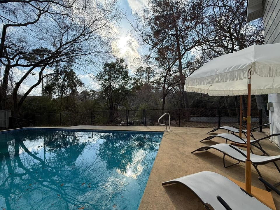Poolside lounging area with comfortable daybeds—perfect for relaxing or napping!