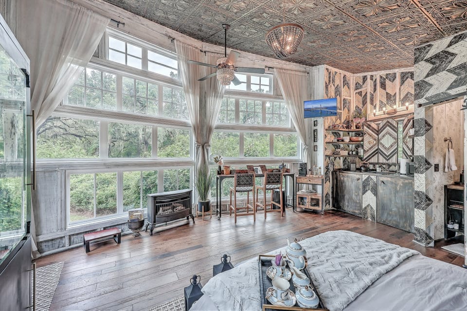 Our expansive wall of windows offers a breathtaking panorama that overlooks the trees and serene marsh, bringing the outdoors in.