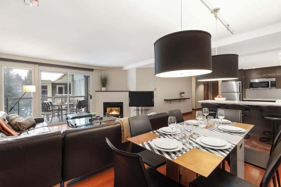 - Open-concept dining and living area ideal for shared moments  
- Sleek design with modern furnishings and balcony access  
- Dine with views of the snow-dusted trees and nearby mountains  
