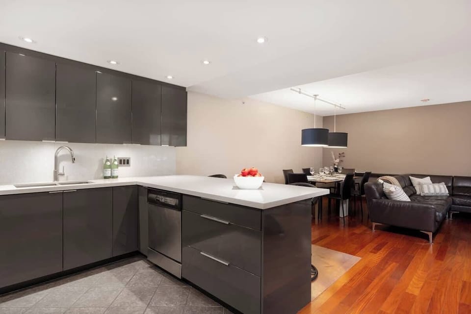 - Stylish open kitchen with sleek cabinetry and bright lighting  
- Perfect for cooking and entertaining in a warm mountain setting  
- Opens to a cozy living and dining area with a modern touch  
