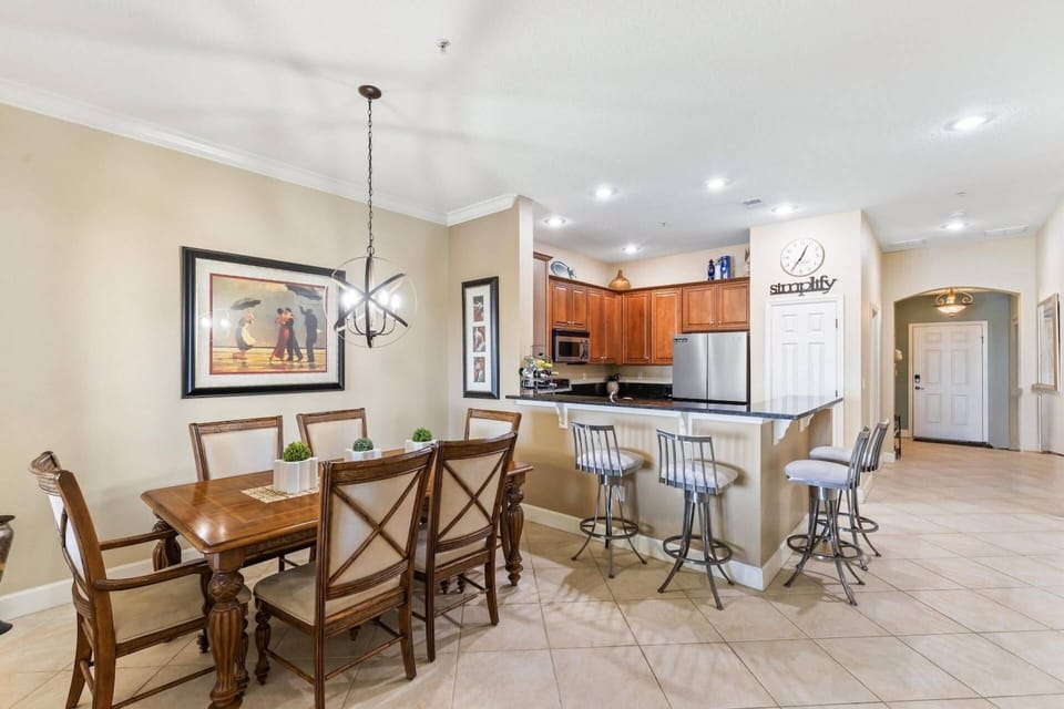 Open-concept kitchen, dining and living area that seamlessly flows to the outdoor patio, offering beautiful views of the lake.