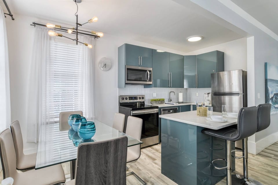 The modern kitchen features a beautiful design, quartz counters, and is fully stocked with everything you need.