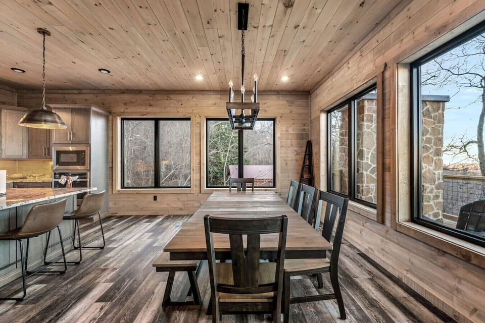 Gather around the spacious dining table with seating for the whole group. Surrounded by large windows, enjoy mountain views as you dine. The rustic yet modern design creates the perfect setting for memorable meals in the heart of the Smoky Mountains.
