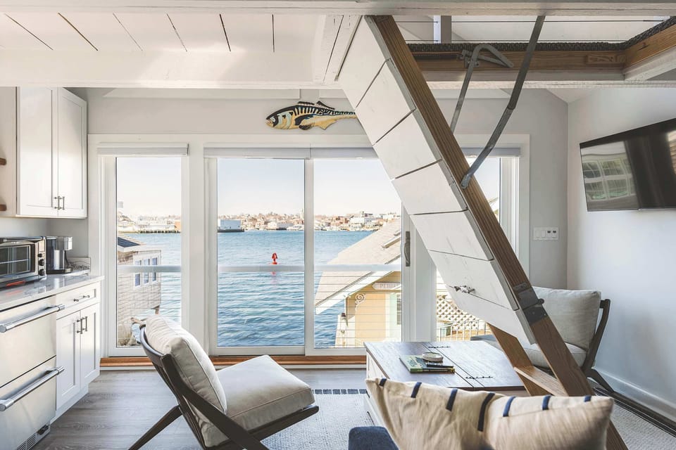 Waterfront living space with boat views and natural light