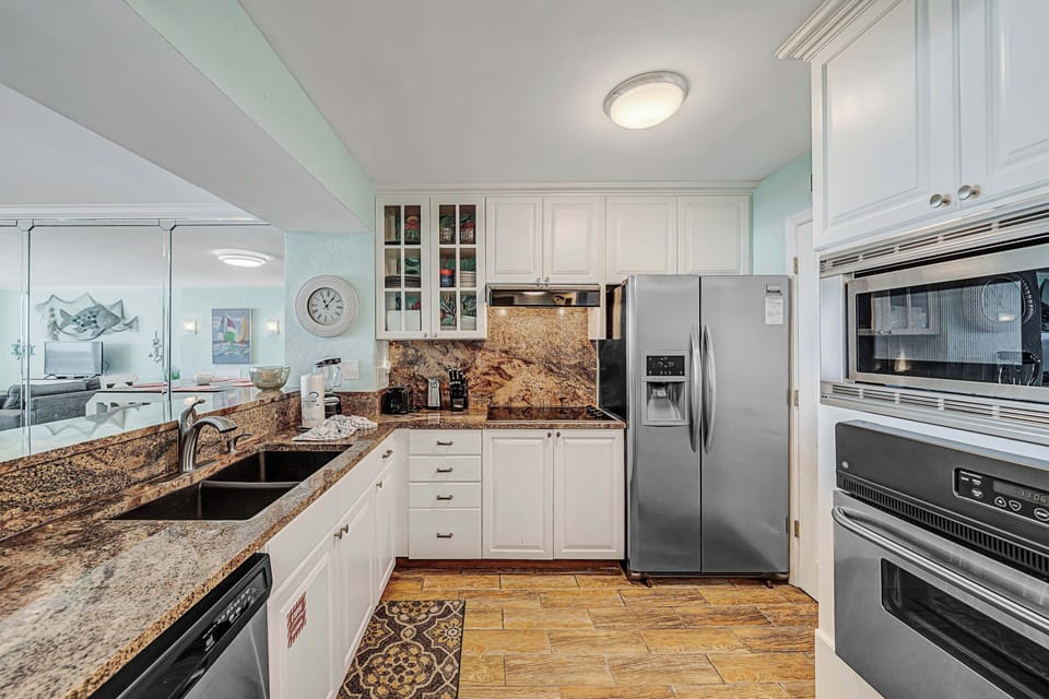The fully equipped kitchen features granite countertops, stainless-steel appliances, and has everything you need to prepare meals for family & friends.