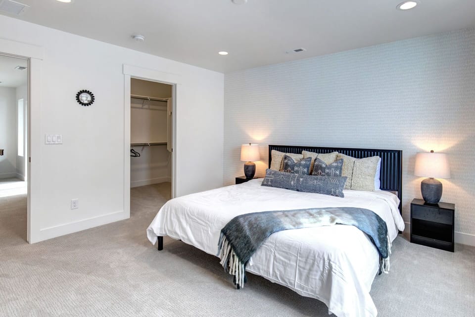 Sink into crisp linens and soft pillows in your serene bedroom, complete with a walk-in closet and soothing accent wall for your perfect night's rest.