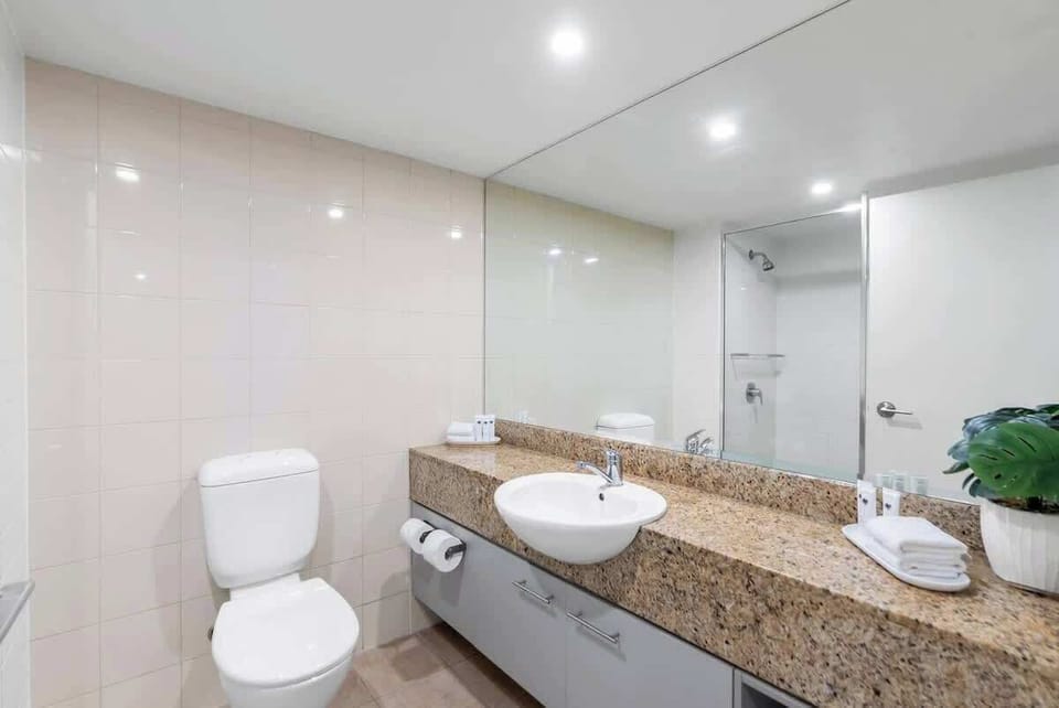 Rejuvenate in the second bedroom’s ensuite, complete with a spacious vanity and refreshing shower—ideal for unwinding after a sun-soaked day at the beach.