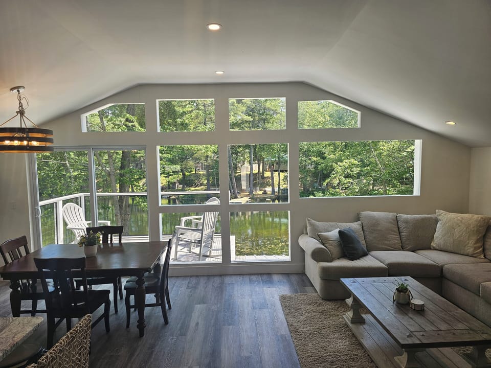 Floor-to-ceiling pond views, soaring ceilings, & natural light