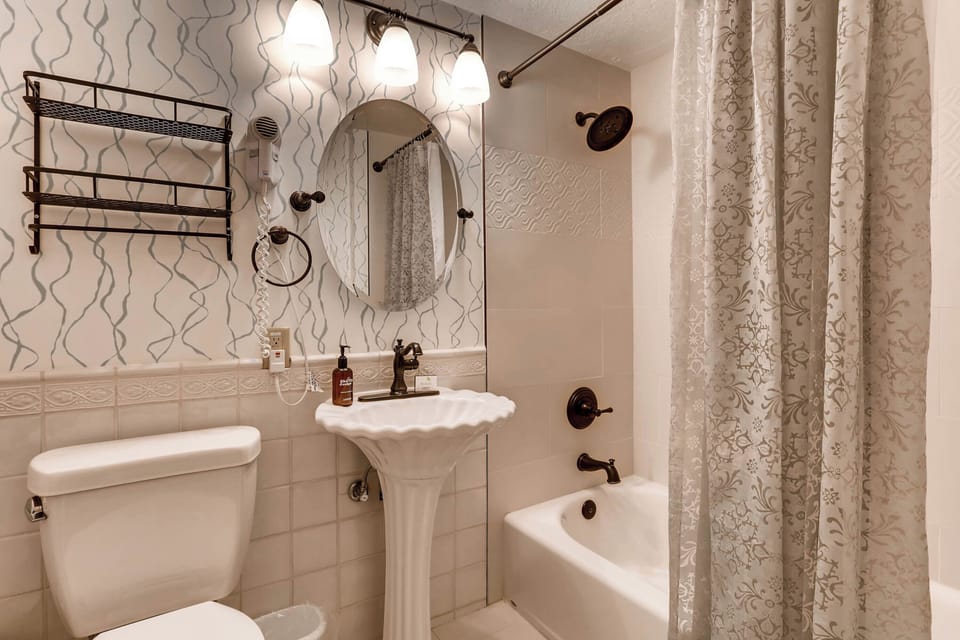 Charming bathroom with vintage-inspired fixtures and soft textiles, creating a serene space for relaxation.