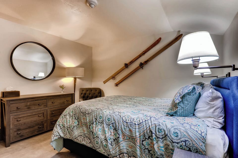 Charming attic-style room with a cozy bed, rustic touches, and a soothing ambiance for restful nights.