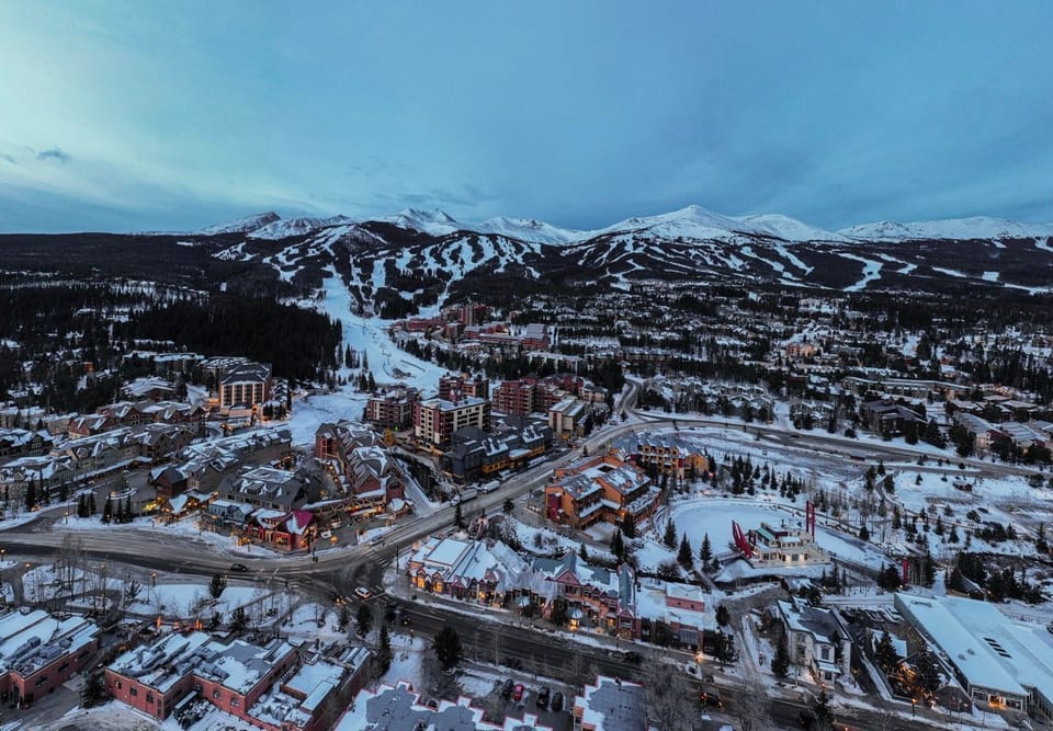 Stunning aerial view of a charming ski town nestled in the heart of the mountains, where adventure and relaxation meet.