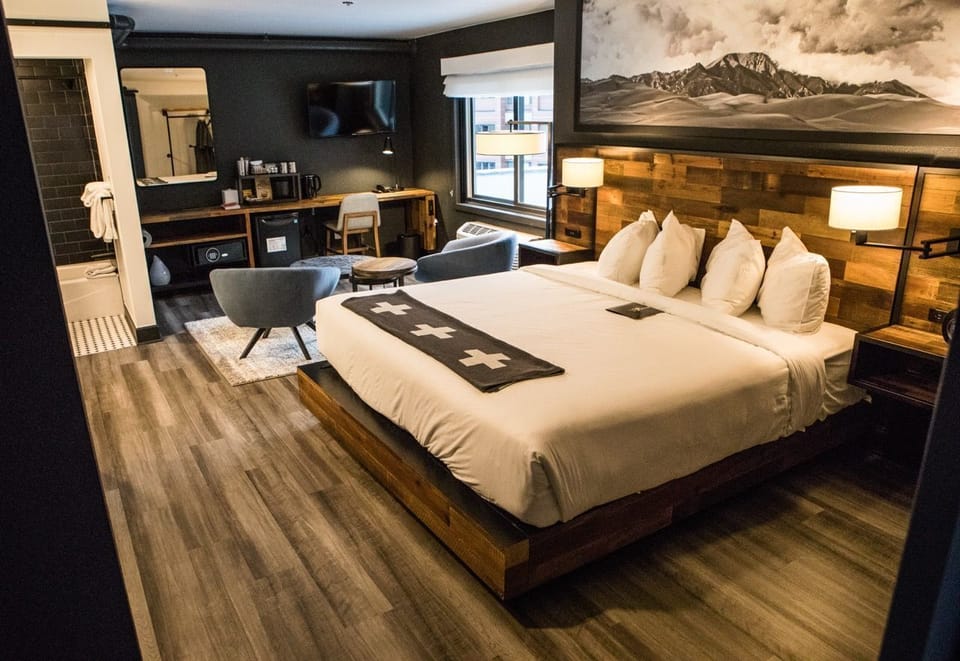 Spacious and inviting room with a plush bed, sleek furnishings, and a serene ambiance.