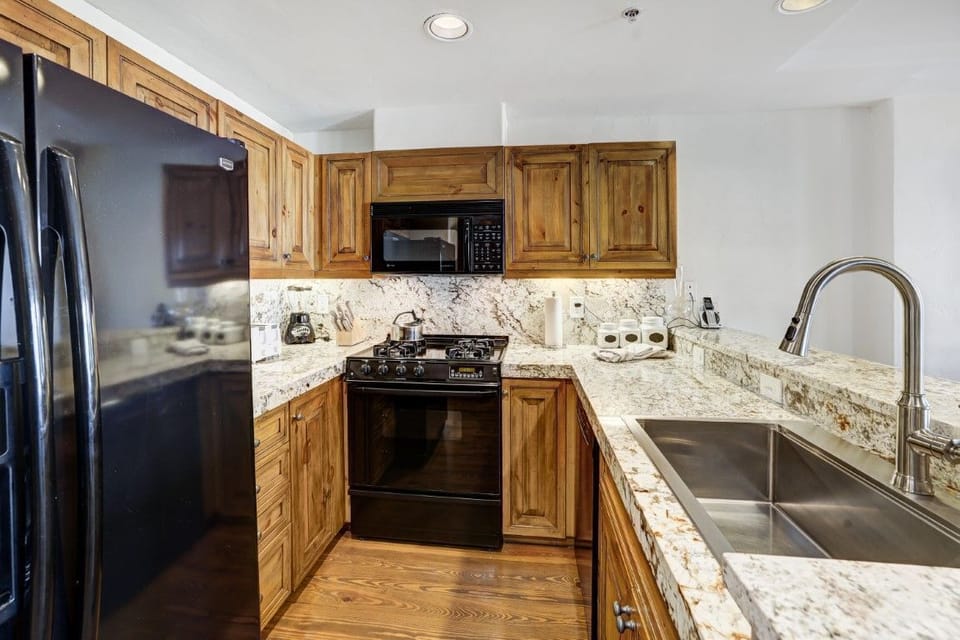 Modern kitchen design with granite counters and spacious cabinets. 
