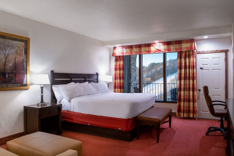 Spacious bedroom with large windows, natural light, and elegant decor that creates a peaceful retreat.