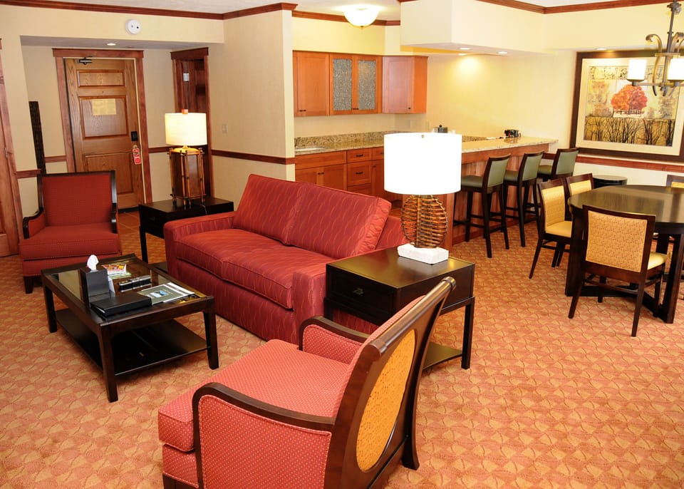 Spacious living area with stylish furniture, warm lighting, and an open layout perfect for relaxation and socializing.