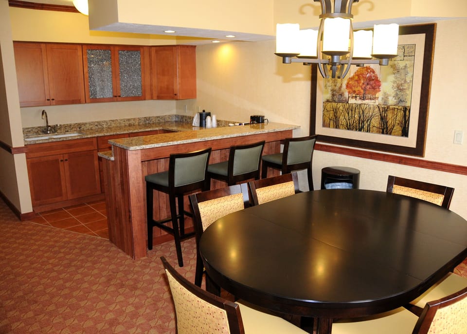 Modern kitchen and dining area with sleek finishes and ample space for preparing and enjoying meals together.