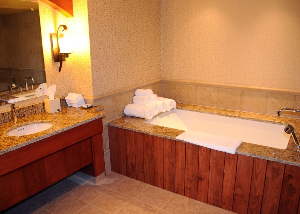 Luxurious bathroom featuring a deep soaking tub and elegant fixtures, ideal for unwinding in comfort.