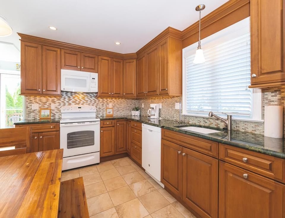 Open kitchen layout with natural light and dining access.