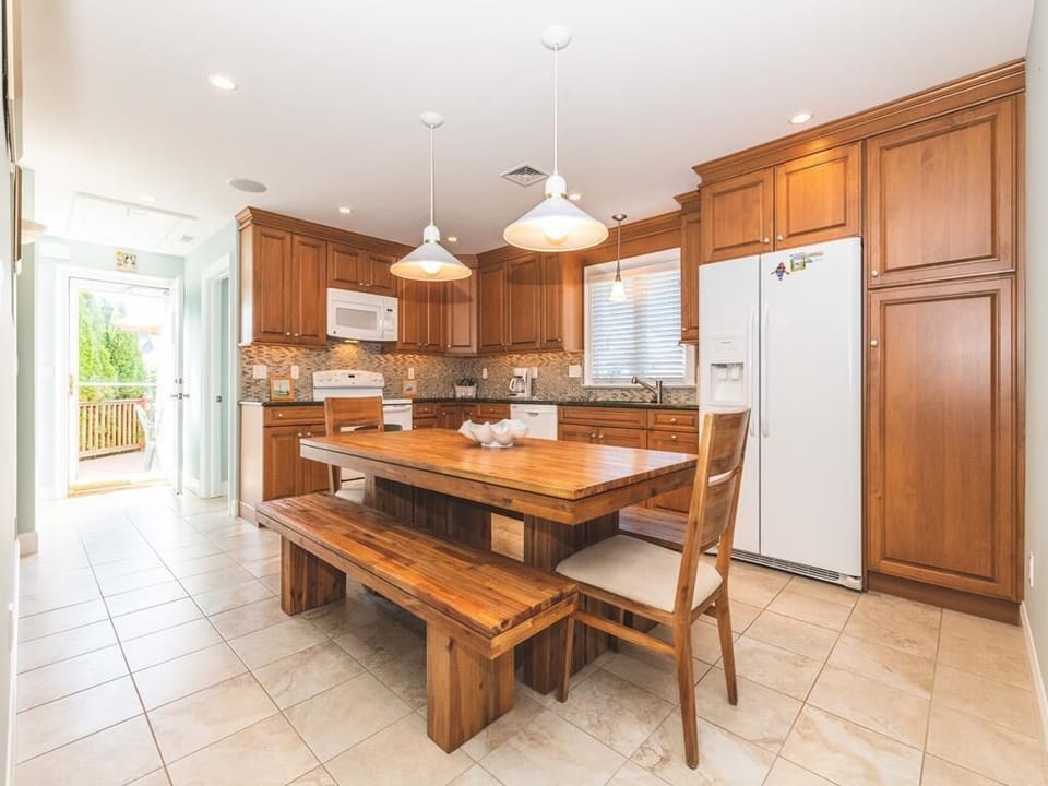 Spacious kitchen with a wooden table seating eight.