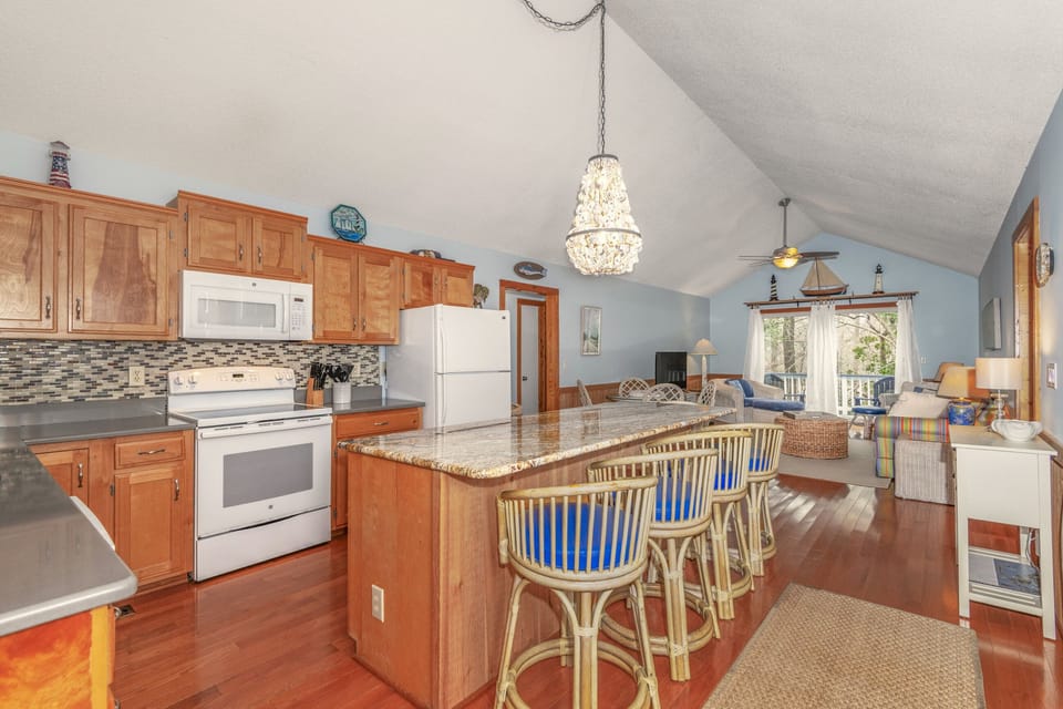 Fully equipped Kitchen, modern appliances, granite countertops, and a spacious dining area.