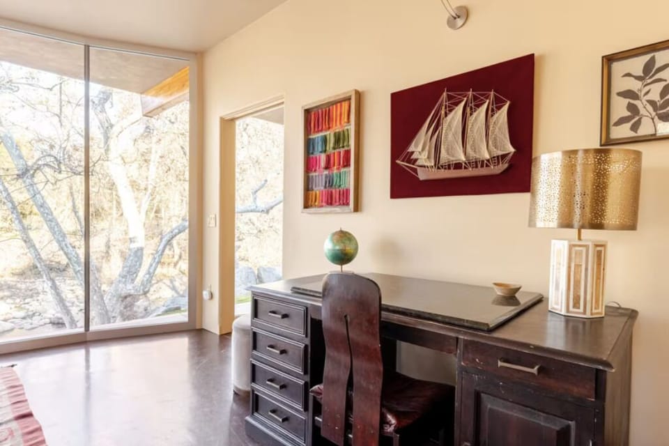 Workspace in the master bedroom with a desk, chair, and relaxing views.