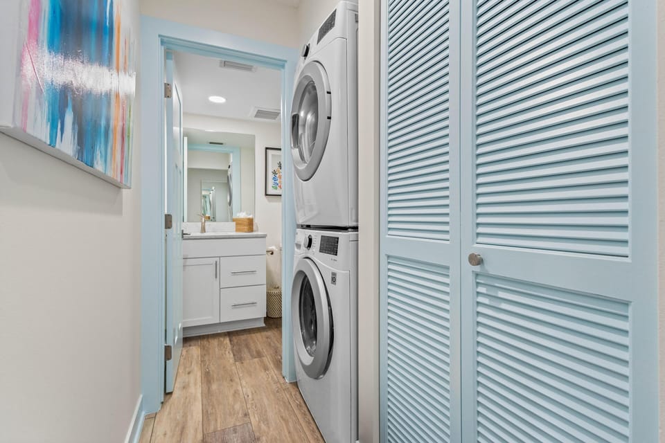 Bright laundry nook with modern stacked washer and dryer
