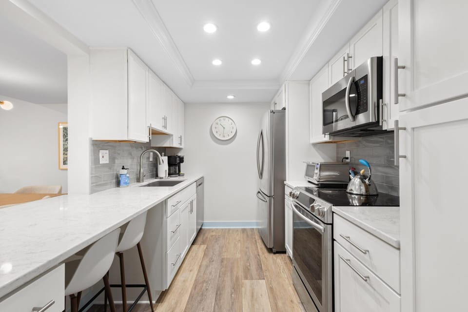 Sleek modern kitchen with bright, open layout and breakfast bar