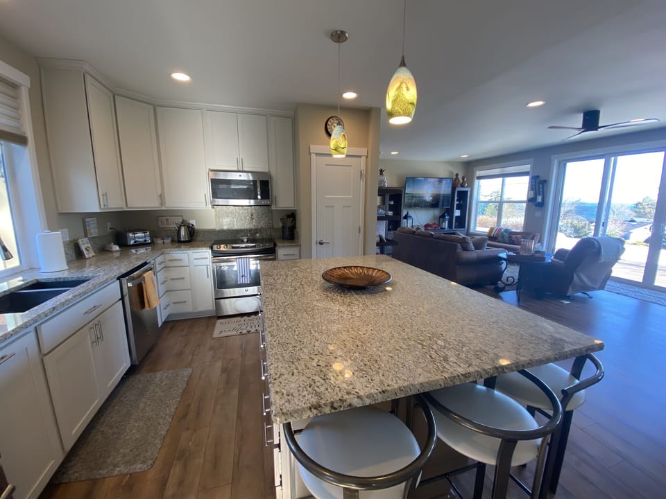 Five barstools sit around the large kitchen island.