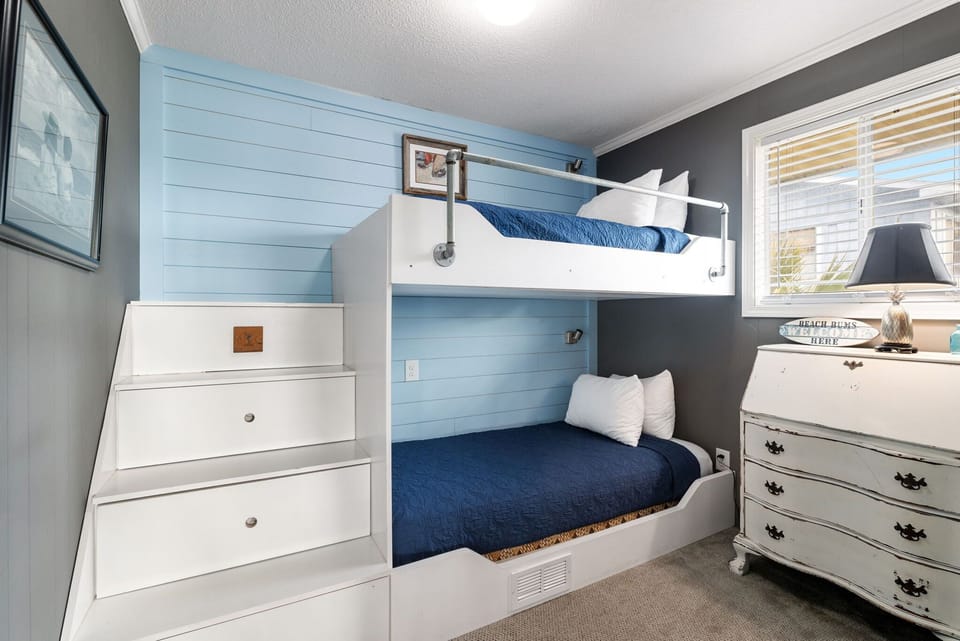 The 2nd room featuring a cozy twin bunk set up is ideal for group getaways or family vacations, offering a space for everyone to relax and recharge!