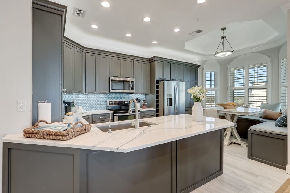 Luxury Kitchen with Stunning Quartz Countertops, Custom Cabinetry, and Stainless Steel Appliances
