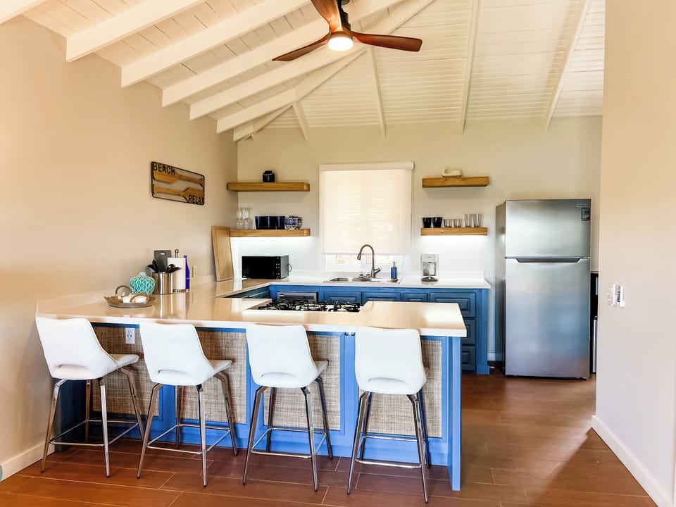 Kitchen with bar height counter seating.