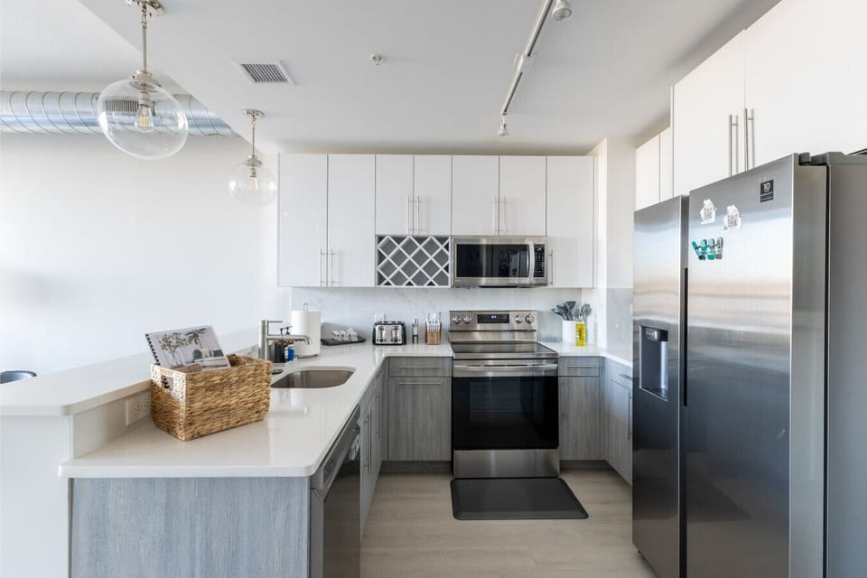 Full Kitchen set up with, Refrigerator, Microwave, Dishwasher, Oven & Ice Machine, Water Dispenser, Floor Mat, Soap Dispenser, Coffee, Tea Kettle, Toaster