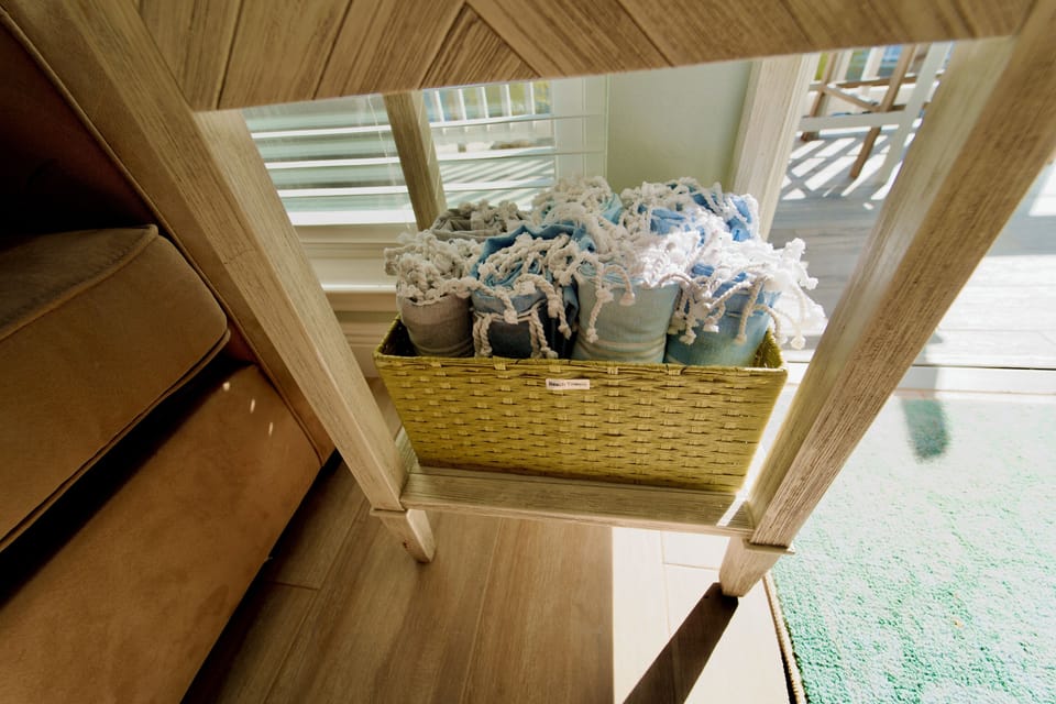 Family fun ready to go—card and board games inside, plus oversized, quick-dry beach towels in soothing coastal colors right on hand.