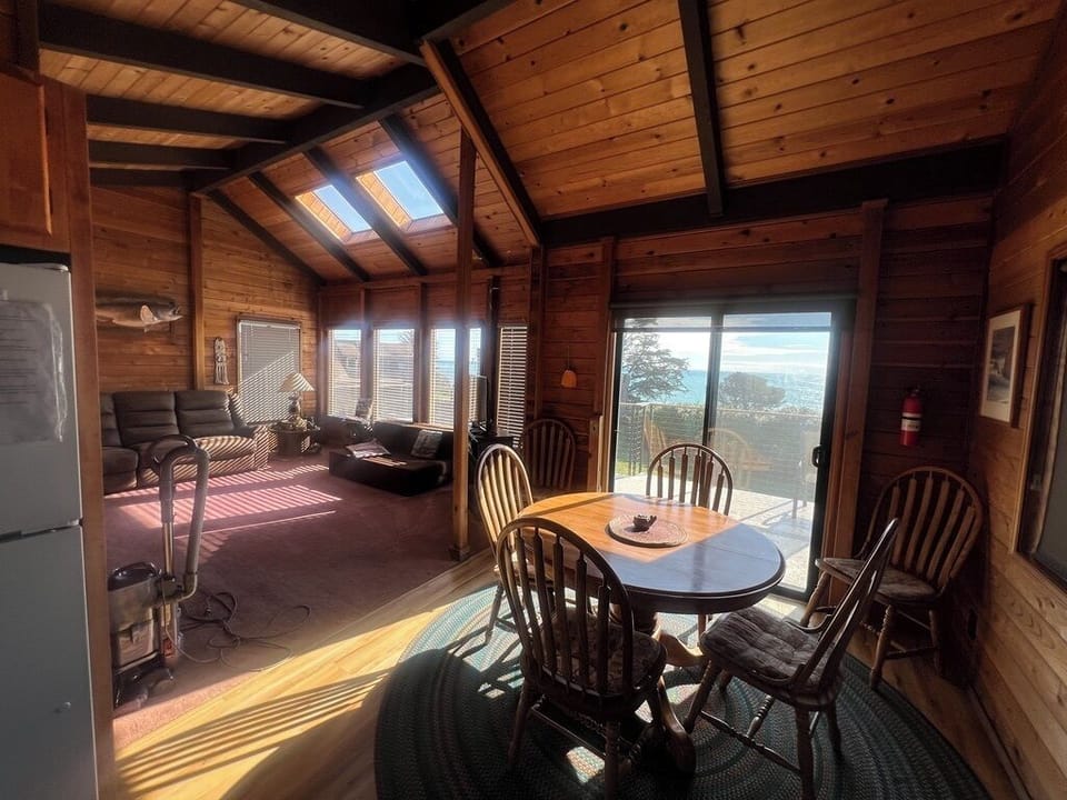 Living room, Futon, dining nook,
Full length deck with chairs table, and Seaview